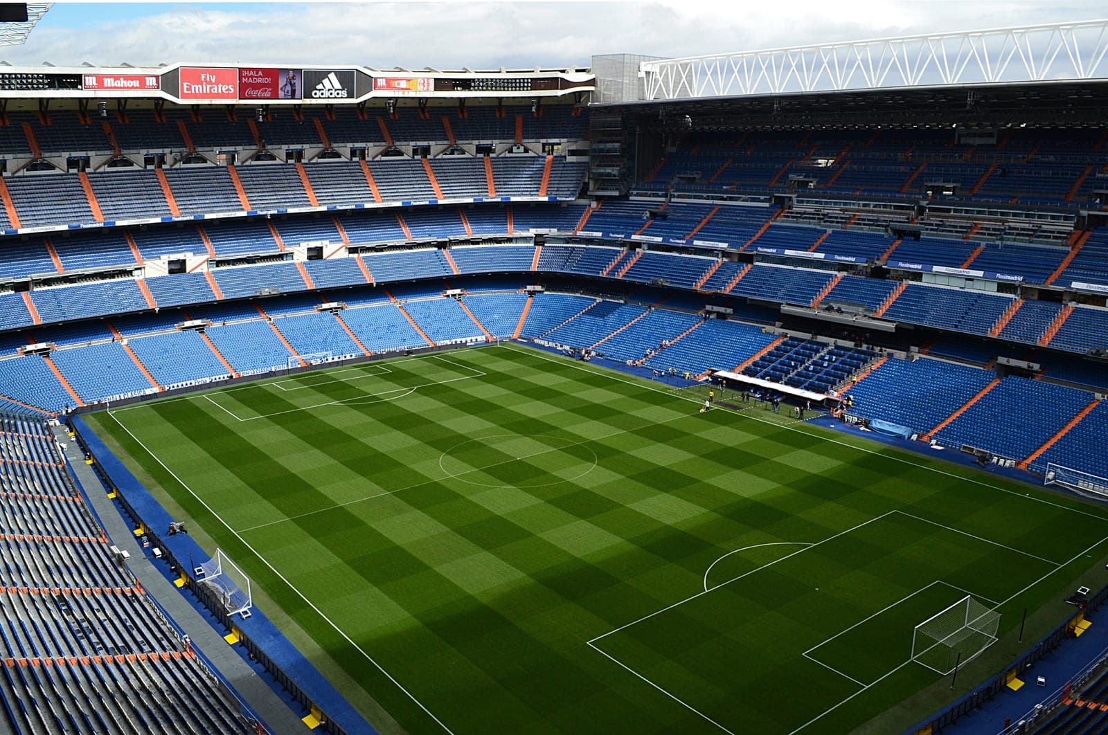 The green pitch and stands of a large football stadium.